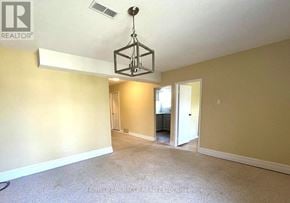 Oshawa (Vanier) apartment for rent - A room with a light fixture hanging from the ceiling.