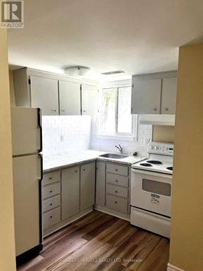 Oshawa (Vanier) apartment for rent - A kitchen with white appliances and cabinets.