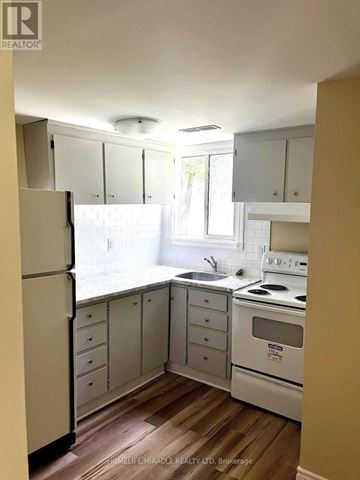 Oshawa (Vanier) apartment for rent - A kitchen with white appliances and cabinets.