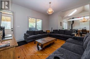 Mono apartment for rent - A living room with a grey couch and a wooden coffee table.