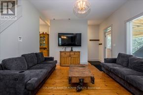 Mono apartment for rent - A living room with a grey couch and a wooden coffee table.