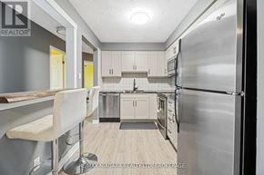 Thorold (Thorold Downtown) condo for rent - A modern kitchen with stainless steel appliances and white cabinets.