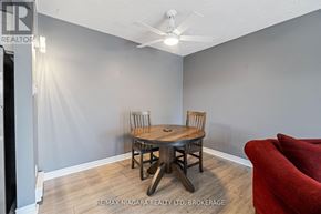 Thorold (Thorold Downtown) condo for rent - A room with a wooden table and chairs and a ceiling fan.