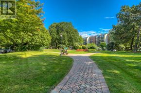 Toronto (Willowdale East) condo for rent - A brick pathway leads through a lush green park.