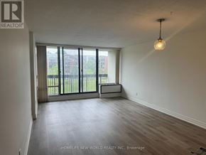 Toronto (Willowdale East) condo for rent - A room with a large window and a wooden floor.