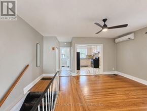 Toronto (Weston-Pellam Park) townhouse for rent - A spacious room with wood flooring and a ceiling fan.