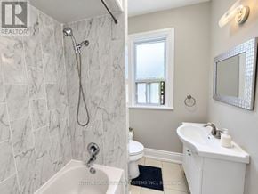 Toronto (Weston-Pellam Park) townhouse for rent - A bathroom with a marble tile shower and a white sink vanity.