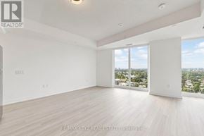 Toronto (Humber Heights) condo for rent - A large, empty room with a view of the city through the windows.