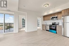Toronto (Humber Heights) condo for rent - A spacious kitchen with wooden cabinets and a white refrigerator.