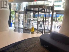 Toronto (Church-Yonge Corridor) condo for rent - A glass revolving door with a yellow caution sign in front of it.
