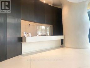 Toronto (Church-Yonge Corridor) condo for rent - A realtor's office with a white reception desk and a large sculpture in the background.
