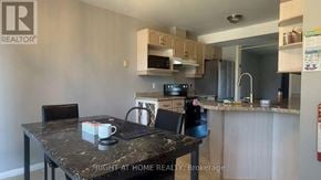 London East (East D) apartment for rent - A kitchen with a table and chairs in front of it.