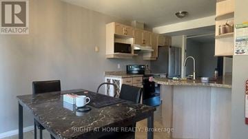 London East (East D) apartment for rent - A kitchen with a table and chairs in front of it.