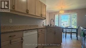 London East (East D) apartment for rent - A kitchen with wooden cabinets and a granite countertop.