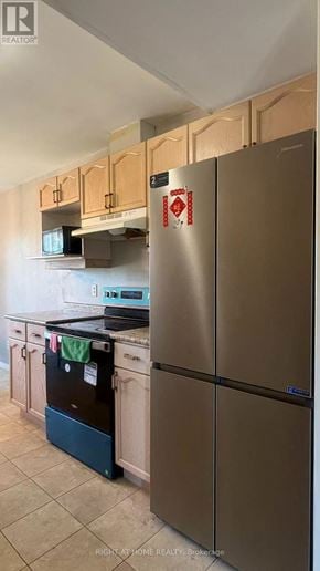 London East (East D) apartment for rent - A kitchen with a stainless steel refrigerator and wooden cabinets.