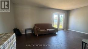 London East (East D) apartment for rent - A living room with a couch, chair, and television.