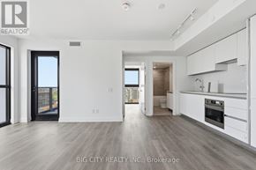 Toronto (Thorncliffe Park) condo for rent - A spacious, modern kitchen with white cabinets and a large island.
