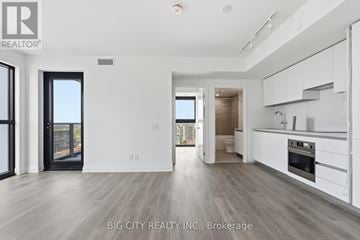 Toronto (Thorncliffe Park) condo for rent - A spacious, modern kitchen with white cabinets and a large island.