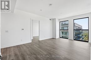 Toronto (Thorncliffe Park) condo for rent - A spacious room with a view of the city through large windows.