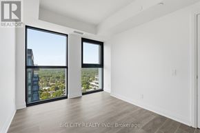 Toronto (Thorncliffe Park) condo for rent - A room with a view of the city through large windows.