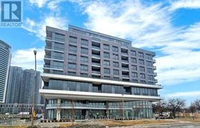 Toronto (Islington-City Centre West) condo for rent - A modern multi-story building with a glass facade and a sign that reads "Loyalty Real Estate Brokerage.".