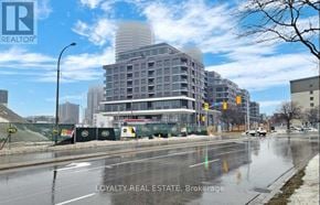 Toronto (Islington-City Centre West) condo for rent - A city street with a large building under construction in the background.