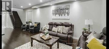 Brampton (Credit Valley) apartment for rent - A living room with a brown leather couch and a coffee table.