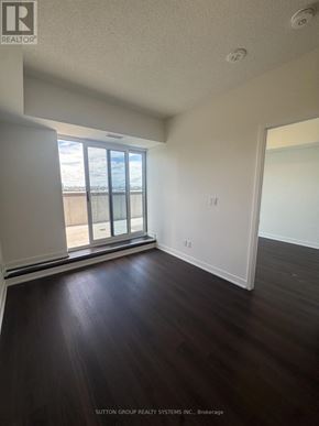 Toronto (Glenfield-Jane Heights) condo for rent - A room with wooden floors and a large window.