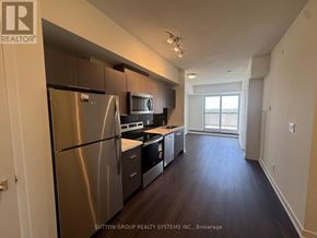 Toronto (Glenfield-Jane Heights) condo for rent - A kitchen with stainless steel appliances and wood floors.