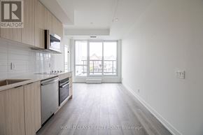 Toronto (Clairlea-Birchmount) condo for rent - A kitchen with wooden cabinets and a white tiled backsplash.