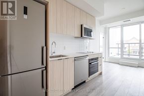 Toronto (Clairlea-Birchmount) condo for rent - A modern kitchen with wooden cabinets and stainless steel appliances.