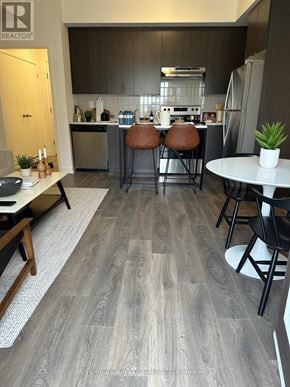 Pickering (Town Centre) townhouse for rent - A modern kitchen with dark wood cabinets and a white countertop.