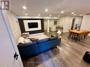 Milton (Co Coates) apartment for rent - A living room with a blue couch and a television.