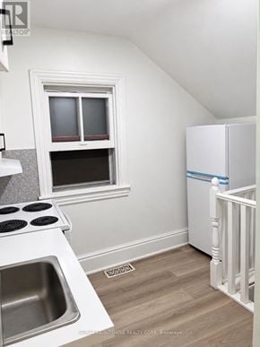 Hamilton (Corktown) apartment for rent - A small kitchen with a sink, stove, and a window.