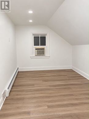 Hamilton (Corktown) apartment for rent - A room with a window and a radiator on the floor.