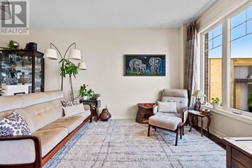 Grimsby (Grimsby Beach) townhouse for rent - A living room with a couch, chair, and a painting on the wall.
