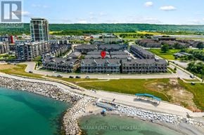 Grimsby (Grimsby Beach) townhouse for rent - A bird's eye view of a coastal area with a promenade and a large building in the background.