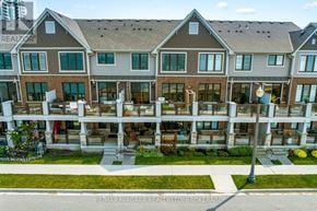 Grimsby (Grimsby Beach) townhouse for rent - A large, multi-story residential building with a lawn in front.