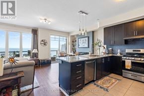 Grimsby (Grimsby Beach) townhouse for rent - A modern kitchen with a large island and a view of the ocean.