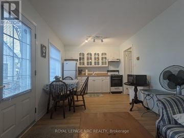 Fort Erie (Crystal Beach) apartment for rent - A kitchen with a table and chairs in the middle of the room.