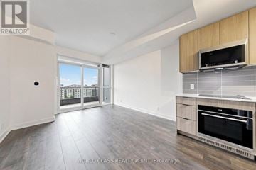Toronto (Clairlea-Birchmount) condo for rent - A spacious living room with a television and built-in cabinetry.