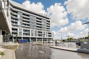 Toronto (Clairlea-Birchmount) condo for rent - A large, modern building with a parking lot in front of it.