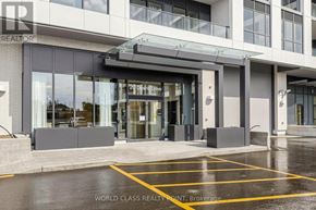 Toronto (Clairlea-Birchmount) condo for rent - The entrance to a building with a glass door and a sign that reads "20th Dr".