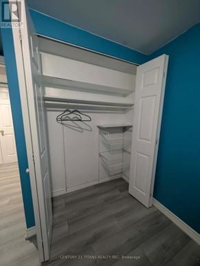 Ajax (South West) apartment for rent - A white closet with a hanger on a rod.