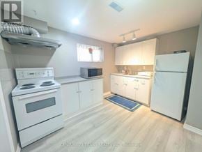 Ajax (South West) apartment for rent - A kitchen with white appliances and cabinets.