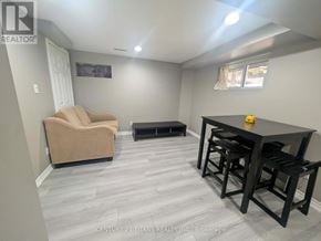 Ajax (South West) apartment for rent - A living room with a couch, a coffee table, and a television.