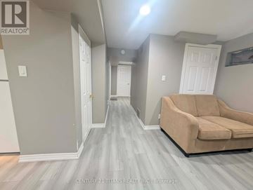 Ajax (South West) apartment for rent - A living room with a couch and a grey floor.