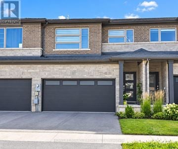 Niagara Falls (Brown) townhouse for rent - A house with a garage and a sign that says REALTOR.