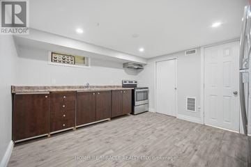 Waterloo apartment for rent - A kitchen with wooden cabinets and a white door.