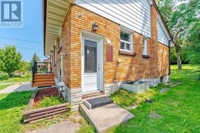 Waterloo apartment for rent - A brick house with a white door and a small porch.
